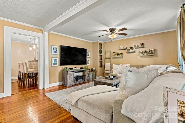 454 N Eastway Dr, Troutman, NC 28166 - living room with a textured ceiling, a ceiling fan, wood finished floors, baseboards, and crown molding
