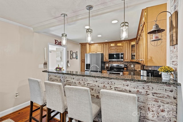 454 N Eastway Dr, Troutman, NC 28166 - kitchen with appliances with stainless steel finishes, crown molding, tasteful backsplash, wood finished floors, and dark stone countertops