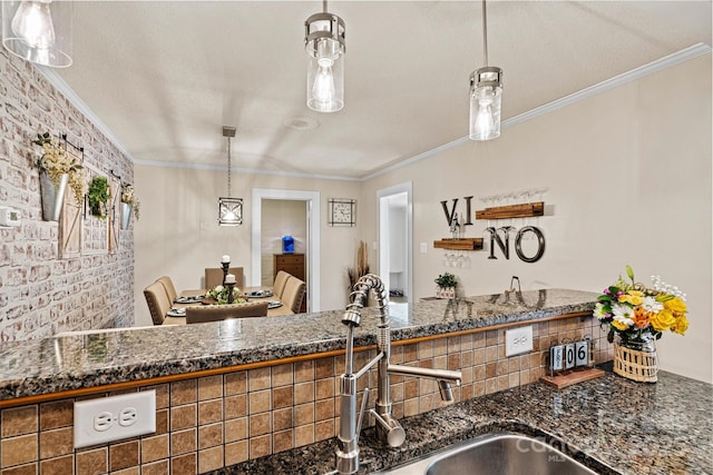 454 N Eastway Dr, Troutman, NC 28166 - kitchen with crown molding, pendant lighting, dark stone countertops, and a sink