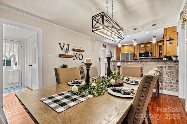 454 N Eastway Dr, Troutman, NC 28166 - dining space with wood finished floors, recessed lighting, crown molding, a chandelier, and a textured ceiling