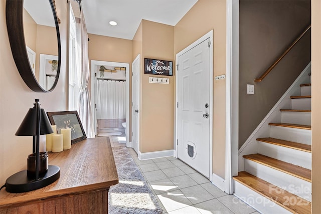 454 N Eastway Dr, Troutman, NC 28166 - entrance foyer with light tile patterned floors, stairway, and baseboards