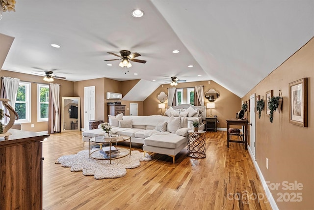 454 N Eastway Dr, Troutman, NC 28166 - living area with a wall mounted AC, plenty of natural light, a ceiling fan, light wood-type flooring, and vaulted ceiling
