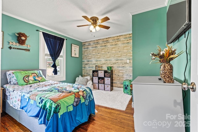 454 N Eastway Dr, Troutman, NC 28166 - bedroom with wood finished floors, ornamental molding, ceiling fan, and an accent wall