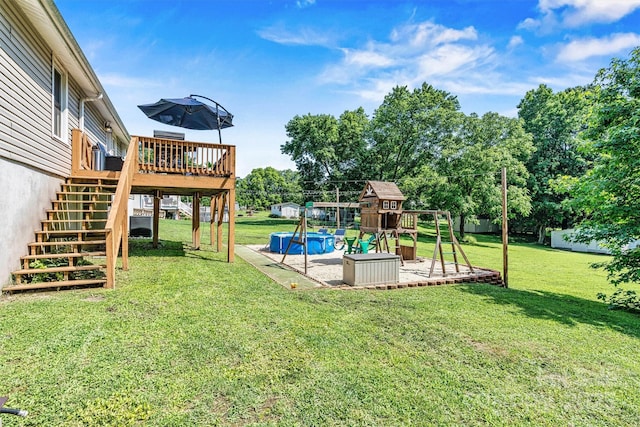 454 N Eastway Dr, Troutman, NC 28166 - view of green lawn with a playground, stairway, a deck, an outdoor pool, and a patio