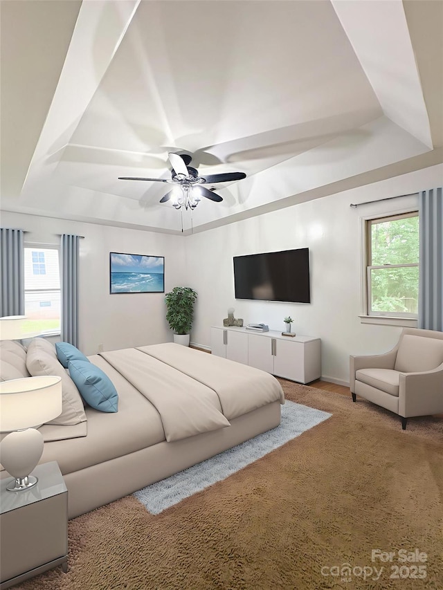 3430 Fincher Blvd, Charlotte, NC 28269 - bedroom with a tray ceiling, carpet, multiple windows, and ceiling fan