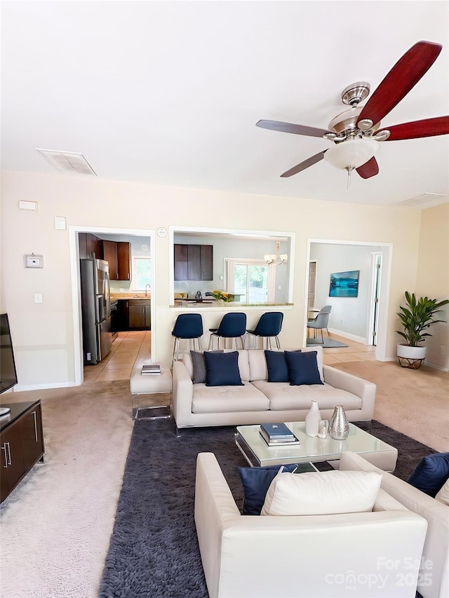 3430 Fincher Blvd, Charlotte, NC 28269 - living room featuring light colored carpet, a ceiling fan, a chandelier, and baseboards