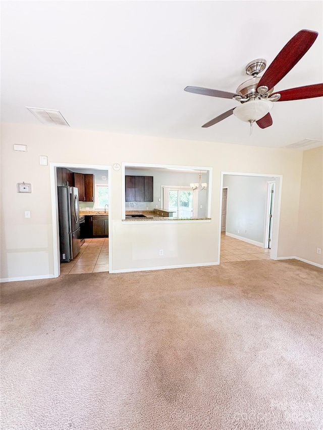3430 Fincher Blvd, Charlotte, NC 28269 - unfurnished living room with ceiling fan, light colored carpet, and baseboards