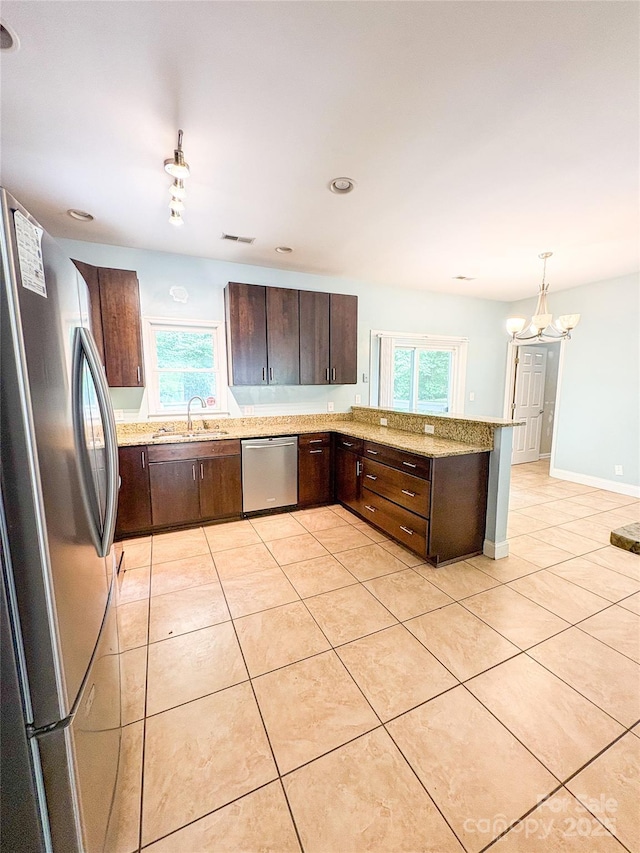 3430 Fincher Blvd, Charlotte, NC 28269 - kitchen featuring stainless steel appliances, a sink, dark brown cabinets, and healthy amount of natural light