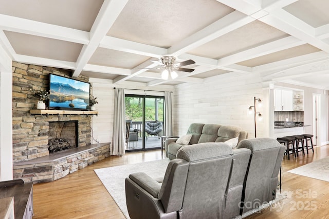 68 Broyles Rd, Hendersonville, NC 28791 - living room with coffered ceiling, a stone fireplace, a ceiling fan, light wood-style floors, and beam ceiling