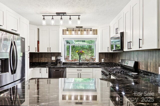 68 Broyles Rd, Hendersonville, NC 28791 - kitchen featuring appliances with stainless steel finishes, a sink, backsplash, white cabinets, and dark stone counters