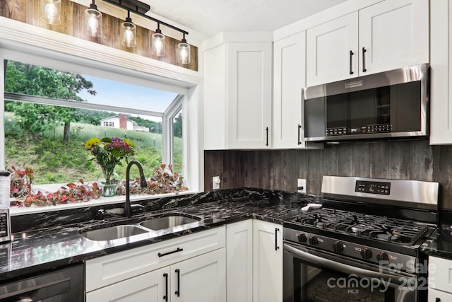 68 Broyles Rd, Hendersonville, NC 28791 - kitchen featuring stainless steel appliances, a sink, white cabinetry, backsplash, and dark stone counters