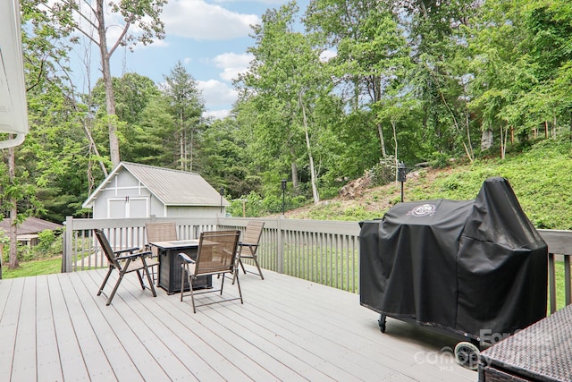 68 Broyles Rd, Hendersonville, NC 28791 - deck featuring an outbuilding, outdoor dining area, a grill, and view of scattered trees