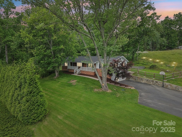68 Broyles Rd, Hendersonville, NC 28791 - view of front facade featuring driveway, covered porch, and a yard