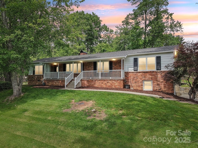68 Broyles Rd, Hendersonville, NC 28791 - single story home featuring brick siding, a porch, and a lawn