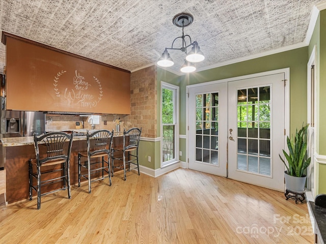 10710 Bristlecone Ct, Mint Hill, NC 28227 - dining space with ornamental molding, wood-type flooring, french doors, and a chandelier