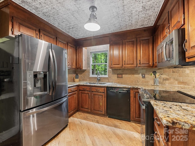 10710 Bristlecone Ct, Mint Hill, NC 28227 - kitchen featuring appliances with stainless steel finishes, light wood-type flooring, backsplash, brown cabinetry, and ornamental molding