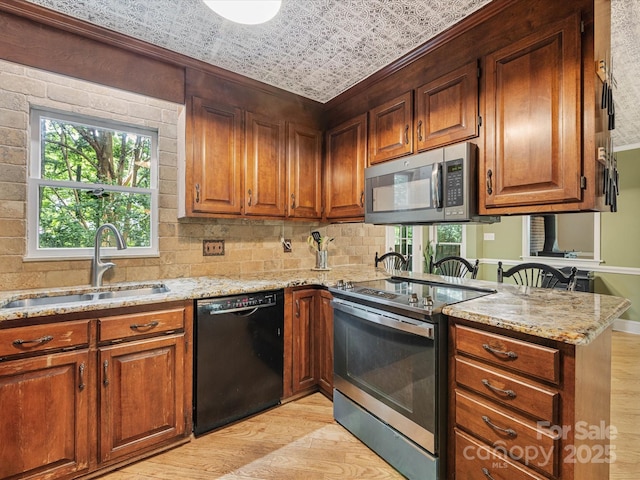 10710 Bristlecone Ct, Mint Hill, NC 28227 - kitchen with stainless steel appliances, light wood-type flooring, light stone counters, a peninsula, and an ornate ceiling