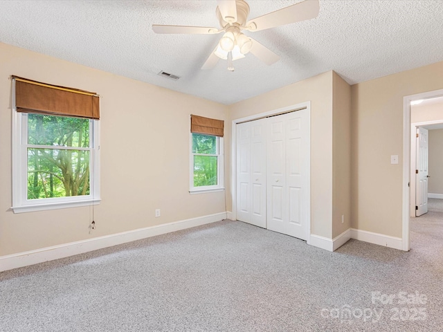 10710 Bristlecone Ct, Mint Hill, NC 28227 - unfurnished bedroom featuring a textured ceiling, carpet, a closet, and a ceiling fan