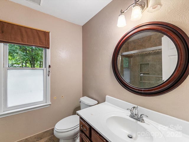 10710 Bristlecone Ct, Mint Hill, NC 28227 - bathroom with vanity, a shower with door, and a textured wall