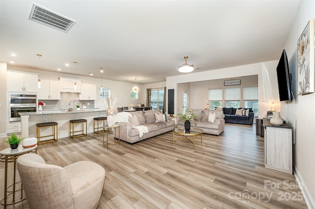 705 Hinterland Ln, Matthews, NC 28104 - living room featuring light wood finished floors and recessed lighting