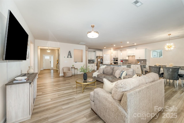 705 Hinterland Ln, Matthews, NC 28104 - living room featuring light wood-style floors, baseboards, and recessed lighting