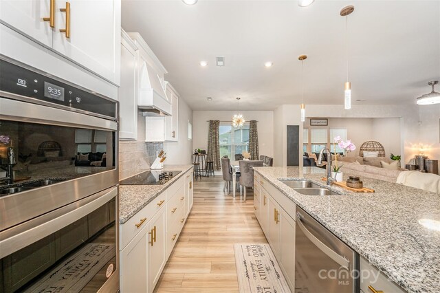 705 Hinterland Ln, Matthews, NC 28104 - kitchen with a sink, appliances with stainless steel finishes, white cabinetry, light wood-style floors, and recessed lighting