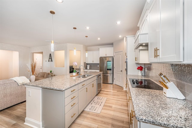 705 Hinterland Ln, Matthews, NC 28104 - kitchen featuring stainless steel appliances, a sink, open floor plan, light wood-style flooring, and white cabinets