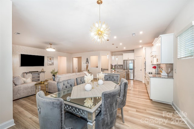 705 Hinterland Ln, Matthews, NC 28104 - dining area featuring a chandelier, light wood finished floors, recessed lighting, and baseboards
