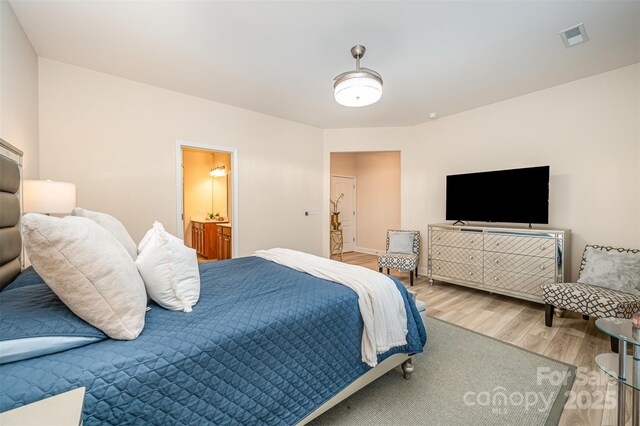 705 Hinterland Ln, Matthews, NC 28104 - bedroom with wood finished floors, baseboards, and ensuite bathroom