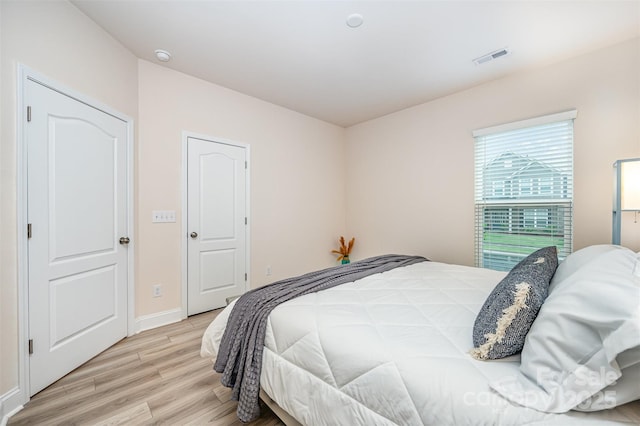 705 Hinterland Ln, Matthews, NC 28104 - bedroom with light wood-style flooring and baseboards