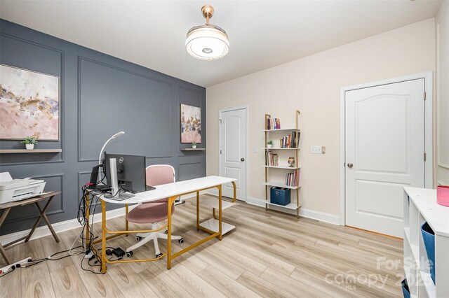 705 Hinterland Ln, Matthews, NC 28104 - office featuring a decorative wall, light wood-style flooring, and baseboards