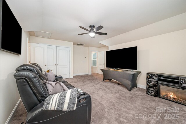 705 Hinterland Ln, Matthews, NC 28104 - carpeted living area featuring baseboards, ceiling fan, attic access, and a glass covered fireplace