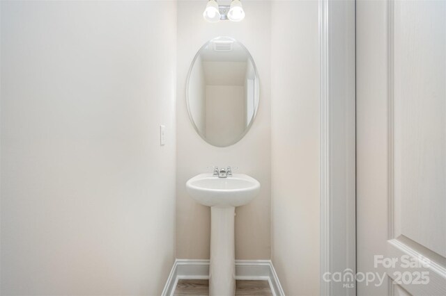 705 Hinterland Ln, Matthews, NC 28104 - bathroom with baseboards and a sink