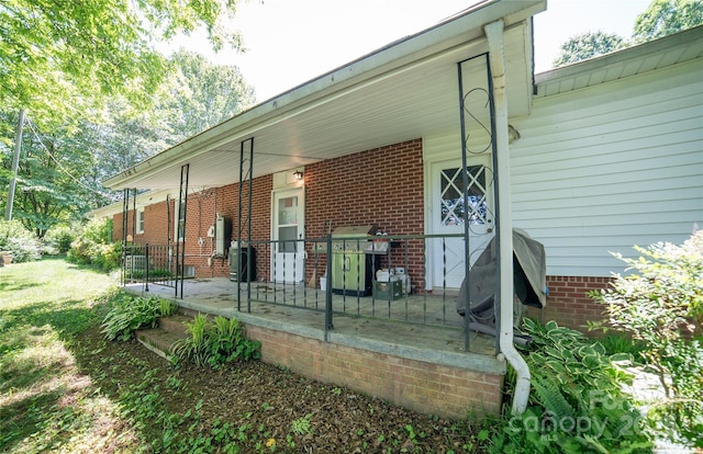 6487 NC-18 Rd, Connelly Springs, NC 28612 - doorway to property featuring a porch, brick siding, and a carport