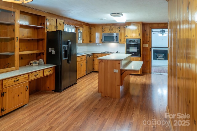 6487 NC-18 Rd, Connelly Springs, NC 28612 - kitchen featuring black appliances, light wood-style flooring, light countertops, open shelves, and a kitchen island