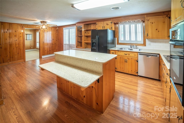 6487 NC-18 Rd, Connelly Springs, NC 28612 - kitchen featuring black refrigerator with ice dispenser, stainless steel dishwasher, a sink, a kitchen island, and open shelves