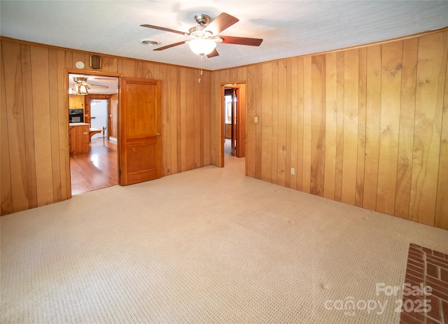 6487 NC-18 Rd, Connelly Springs, NC 28612 - carpeted spare room with a ceiling fan and wood walls