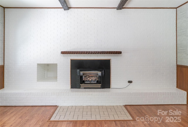 6487 NC-18 Rd, Connelly Springs, NC 28612 - detailed view of wood finished floors, a brick fireplace, beam ceiling, and ornamental molding