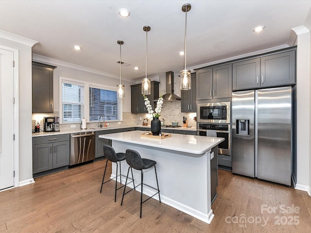 5811 Mantle Way, Kannapolis, NC 28081 - kitchen with stainless steel appliances, ornamental molding, wall chimney range hood, a kitchen breakfast bar, and a kitchen island