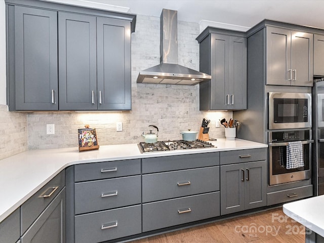 5811 Mantle Way, Kannapolis, NC 28081 - kitchen featuring wall chimney exhaust hood, appliances with stainless steel finishes, backsplash, light countertops, and gray cabinets