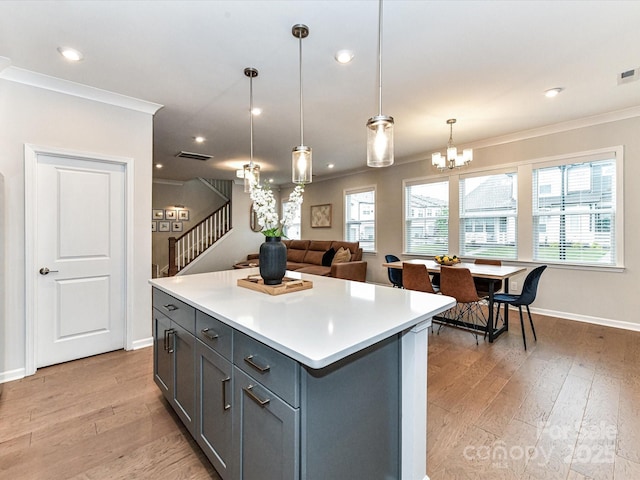 5811 Mantle Way, Kannapolis, NC 28081 - kitchen featuring crown molding, light wood-style flooring, baseboards, a chandelier, and light countertops