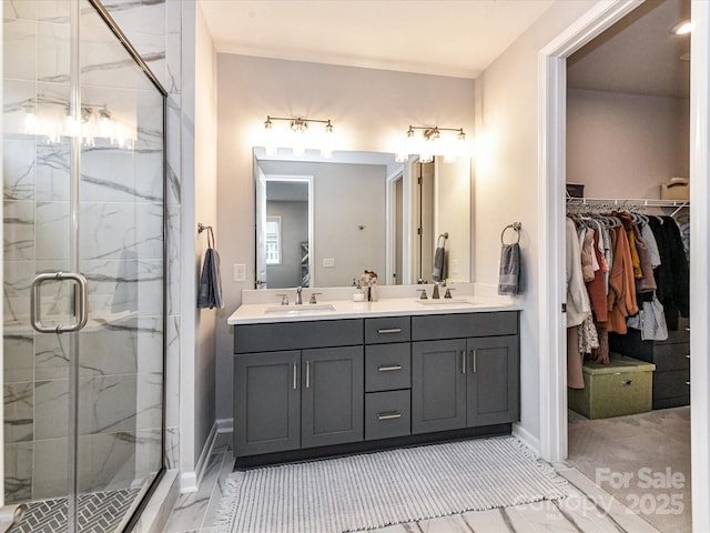 5811 Mantle Way, Kannapolis, NC 28081 - bathroom featuring double vanity, a stall shower, marble finish floors, a walk in closet, and baseboards