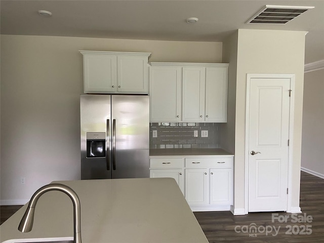 108 Red Juniper Way, Statesville, NC 28625 - kitchen featuring stainless steel fridge with ice dispenser, decorative backsplash, white cabinetry, dark wood finished floors, and baseboards