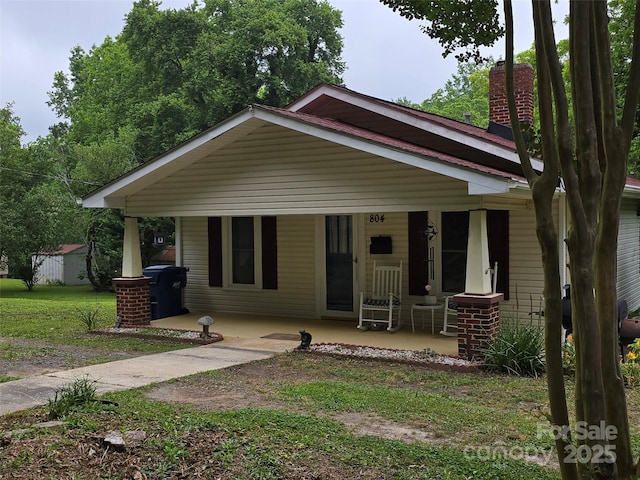 804 Dennis St, Troy, NC 27371 - bungalow-style home featuring a porch and a chimney