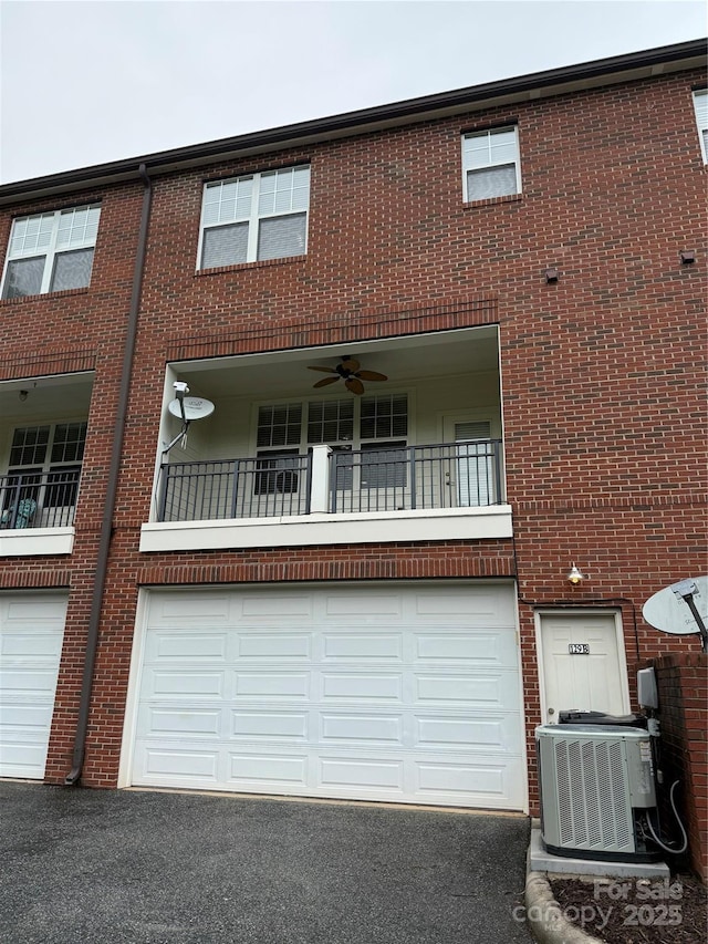 129 Steinbeck Way Unit B, Mooresville, NC 28117 - view of front facade with a garage, central AC unit, driveway, and brick siding
