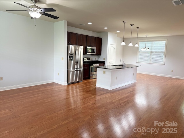 129 Steinbeck Way Unit B, Mooresville, NC 28117 - kitchen featuring appliances with stainless steel finishes, dark countertops, a sink, recessed lighting, and open floor plan