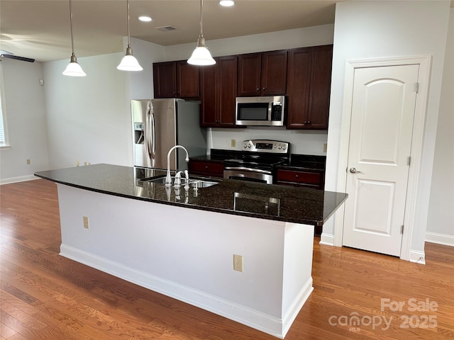 129 Steinbeck Way Unit B, Mooresville, NC 28117 - kitchen featuring stainless steel appliances, a sink, dark brown cabinetry, light wood-type flooring, and pendant lighting