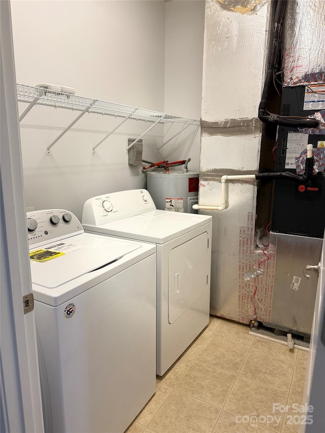 129 Steinbeck Way Unit B, Mooresville, NC 28117 - washroom featuring washing machine and clothes dryer, electric water heater, light tile patterned floors, and heating unit