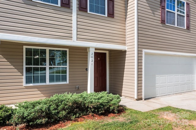 2021 Tarzi Ln, Charlotte, NC 28215 - view of exterior entry featuring a garage and driveway