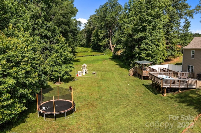 2021 Tarzi Ln, Charlotte, NC 28215 - view of green lawn with a trampoline and a deck